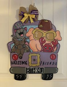 a welcome sign hanging on the front door