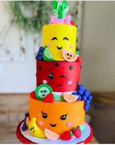 there is a multi layer cake decorated with fruits and veggies on the top