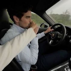 a man sitting in the driver's seat of a car