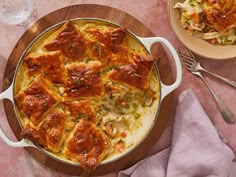 a casserole dish with meat and vegetables in it