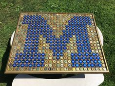 a table made out of bottle caps sitting in the grass