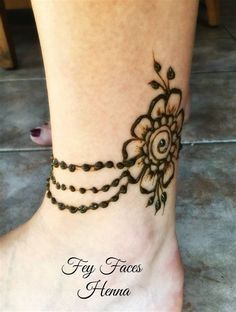 a woman's foot with henna tattoos on her feet and the words fly faces home written in black ink