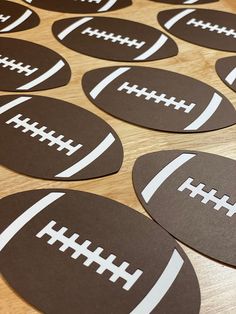 black and white football shaped stickers sitting on top of a wooden table