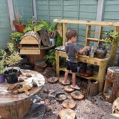 a young boy standing in front of an outdoor kitchen