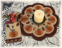 a candle is sitting on a doily next to other items