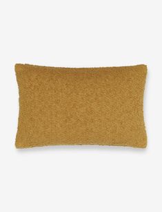 a brown pillow on a white background