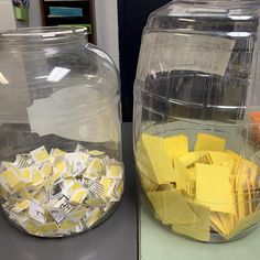 two glass containers filled with yellow and white notes