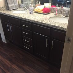 a bathroom with two sinks and a large mirror