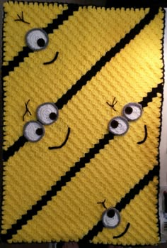 a crocheted blanket with eyes on it