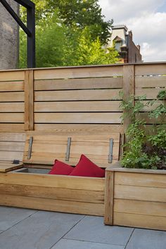 a wooden bench sitting next to a planter filled with flowers