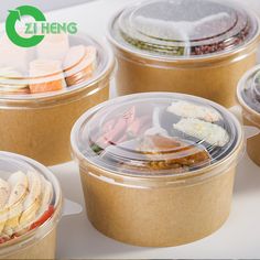 several plastic containers filled with food on top of a white countertop next to each other