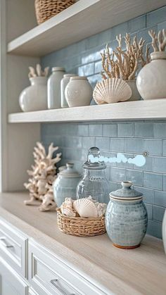 the shelves in this kitchen are filled with sea shells and other decorative items, such as vases