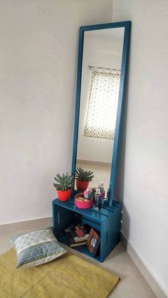 a room with a blue shelf and mirror