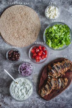 the ingredients to make grilled chicken falafel laid out on a table