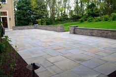 an outdoor patio with stone walls and steps