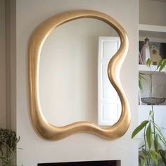 a mirror that is on the wall above a fireplace