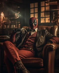 a man in a red suit and mask sitting on a brown chair with his legs crossed