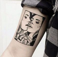 a woman's arm with a black and white tattoo design on the left forearm