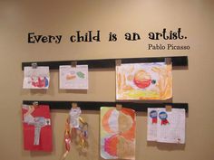 there is a sign on the wall that says every child is an artist, pablo praso