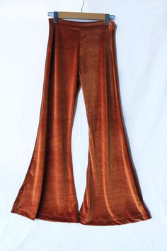 A bohemian wardrobe is not complete without a pair of quality velvet bells!Stretch velvet in burnt orange inspired by the 70's gypsy rocker inner you! The most flattering cut just skims your thigh while blending into a super flare which means minimal flare is lost if you need to take them up.Perfect for lounging or festival wear. Made with no elastic in the waistband yet only the stretch from the fabric for extra comfort.  Available in 4 sizesThe model is wearing a size small, however she is a s Burnt Clothes, Mid Size 70s Fashion, Retro Fall Flares, Retro Full-length Fall Flares, Orange And Black Outfit, Rust Flare Pants, Fall Velvet Flare Bottoms, Velvet Flares, Birthday Fits