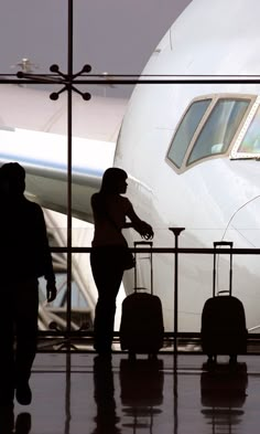 two people walking towards an airplane at the airport