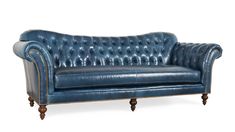 a blue leather couch sitting on top of a white floor