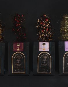 five different types of tea bags lined up against a black background with flowers in them