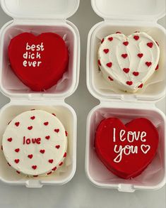 four heart shaped cakes in plastic containers with writing on them