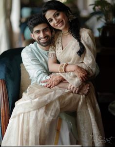 a man and woman sitting on top of a couch