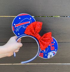 "*These cute ears are Bills themed. Ears are trimmed with a white bead and a red sequin bow. Ears top a blue 1\" satin headband and rhinestones added for some bling *Headband and bow color may vary slightly but will still match the fabric. All fabric has different patterns so pattern may not be exact as photo shown but will be close. No major changes will be made unless requested *I do accept custom orders, just send me a message *Please handle with care as these are a handmade item *All ears ar Mouse Headband, Buffalo Football, Satin Headband, Sequin Bow, Red Sequin, Minnie Ears, Buffalo Ny, Beaded Trim, Mouse Ears