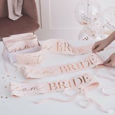 a bride and groom sashes on a table with confetti