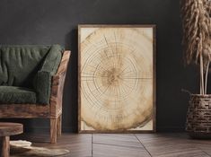 a chair sitting next to a wooden table in front of a painting on the wall