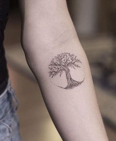 a small tree tattoo on the arm