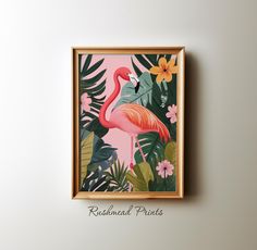 a pink flamingo with tropical leaves and flowers in a wooden frame on the wall