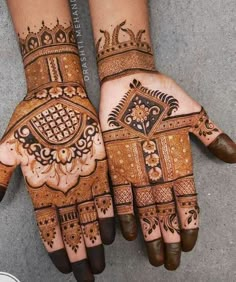 two hands with henna designs on them