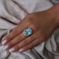 A Breathtakingly Striking HANDMADE 14k White Gold Ring with Beautiful Cushion Cut Paraiba Tourmaline in Green-Blue color! The GEM is 16.03 CT and measures 17.89x12.56x9.18 mm! This Stone will take your breath away, especially on the sunlight! You will want to look at this stone endlessly. The mounting is a masterpiece! HANDMADE 14K White Gold Diamond Mounting (tested), that was is custom made to Accommodate this Beauty of a Gem in a V-prongs setting! Super FINE Workmanship on the Diamond v-split Paraiba Tourmaline Ring, Paraiba Tourmaline, Tourmaline Ring, 14k White Gold Ring, White Gold Ring, Cushion Cut, White Gold Rings, Rings Statement, White Gold Diamonds