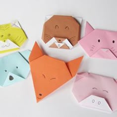 four folded origami animals sitting next to each other