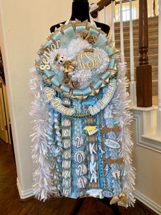 a blue and white christmas tree decoration on top of a mannequin