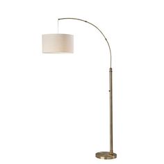 a floor lamp with a white shade on the base and a round light fixture in front of it