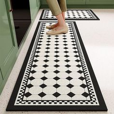 a woman is standing on the kitchen floor