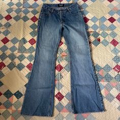 🌵Iconic mid rise y2k jeans from brand Angels in a nice medium wash with some big ol flares at the hem. I love the 2000s doing the hippie look and these are a quintessential look from that era. Branded on the back patch and large back pockets. Zips at the fly with a button at the waist. No stretch - please double check measurements as these do fit a medium rise.  🌵Condition: Great vintage condition, small frayed area on back of pant leg by hem. Please see photos. No other stains, rips holes or issues 🌵Material ❉ 100% Cotton 🌵 Size (measurements taken laid flat, double for body measurement): ❉ Will fit a modern size small, 28 inches at the low waist ❉ 14 inches at the low waist ❉ 19.5 inches at the hip ❉ 9.25 inch rise ❉ 31 inch inseam 🌵Return/Cancellation Policy (BY BUYING FROM MY STOR Y2k High Rise Flare Jeans With Five Pockets, Y2k Denim Blue Flare Jeans, Y2k Style Denim Blue Flare Jeans, Y2k Style Dark Wash Flare Jeans, Y2k Full Length Cotton Flare Jeans, 90s Dark Wash Denim Flare Jeans, 90s Style Dark Wash Denim Flare Jeans, Y2k Style Dark Wash Mid-rise Flare Jeans, Y2k Style Dark Wash Cotton Flare Jeans