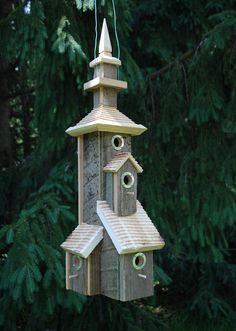 a wooden bird house hanging from a tree