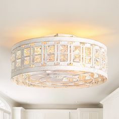 a white chandelier hanging from the ceiling in a room