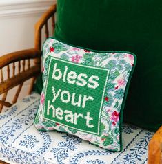 a green pillow sitting on top of a wooden chair