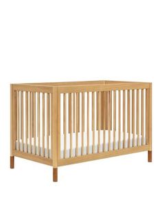 a wooden crib with white sheets on the bottom and side rails, against a white background