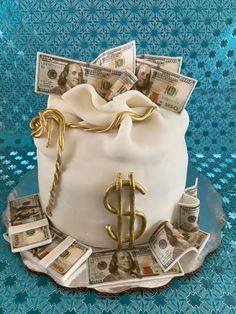 a cake decorated with money on top of a table