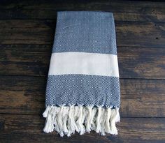 a blue and white towel laying on top of a wooden floor