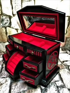 a black and red jewelry box with drawers