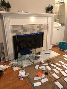 the fireplace is being remodeled and covered with papers