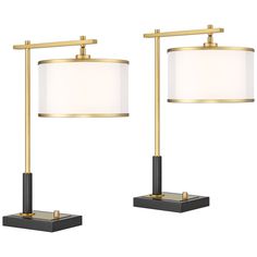 two black and gold lamps with white shades